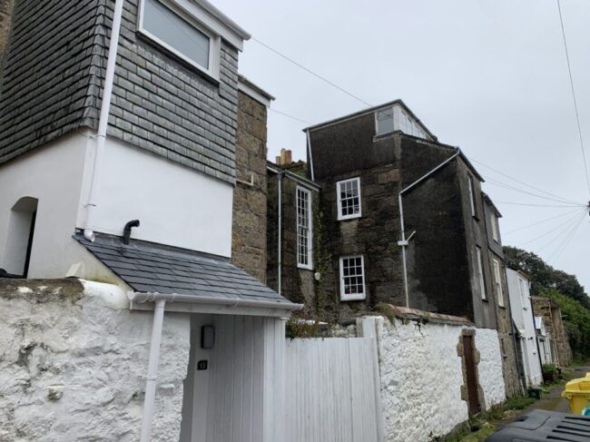 Rear yards and wings of Regent Square, Penzance, a Grade II listed terrace. These aspects of a building are liable to a greater deal of change and are unlikely to be recorded in detail or have an up-to-date description. Click the image to read the full list description.